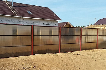 Забор из поликарбоната на металлическом каркасе красного цвета